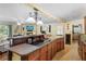 Spacious kitchen island with cooktop and bar, opening to living space with fireplace and modern decor at 1090 Braddock Rd, Deltona, FL 32725