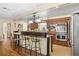 View of an open kitchen with stainless steel appliances, a kitchen island with bar seating and decorative chandelier at 1090 Braddock Rd, Deltona, FL 32725