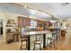 Well-equipped kitchen featuring breakfast bar, wood cabinetry, and modern appliances at 1090 Braddock Rd, Deltona, FL 32725