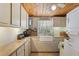 Laundry room with countertop, washer, dryer, cabinets, and wood ceiling at 1090 Braddock Rd, Deltona, FL 32725