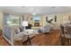 Spacious living room with hardwood floors, fireplace, comfortable seating, and natural light at 1090 Braddock Rd, Deltona, FL 32725