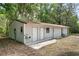 A metal outbuilding with double doors, a single door, and an outdoor sink at 1090 Braddock Rd, Deltona, FL 32725
