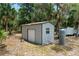 Metal outbuilding with a roll up door, a single door, and attached water filtration equipment at 1090 Braddock Rd, Deltona, FL 32725