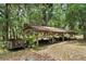A wooden storage shed filled with machinery and equipment, useful for property maintenance at 1090 Braddock Rd, Deltona, FL 32725