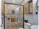Elegant shower with stone tile, glass door, a built in bench, and rustic wood accents at 1090 Braddock Rd, Deltona, FL 32725