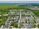 An aerial view of a neighborhood near a wooded area, showcasing a home marked with a star at 1101 Rush Ct, Celebration, FL 34747
