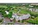 A scenic aerial view featuring a meticulously manicured golf course and the clubhouse at 1101 Rush Ct, Celebration, FL 34747