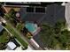 Aerial view showcases a pool, hot tub and solar panels, surrounded by lush landscaping and mature trees at 1101 Rush Ct, Celebration, FL 34747