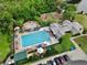 Aerial view of a community pool and clubhouse amenities including playground, hot tub, and seating at 1101 Rush Ct, Celebration, FL 34747