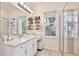 Bright bathroom featuring a walk-in glass shower and dual sink vanity with storage at 1101 Rush Ct, Celebration, FL 34747