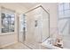 Modern bathroom featuring a glass walk-in shower, bathtub, and neutral finishes at 1101 Rush Ct, Celebration, FL 34747