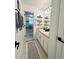A bathroom view showcases a double vanity with shelves, with a decorative patterned rug leading to a shower at 1101 Rush Ct, Celebration, FL 34747