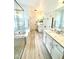 Bright bathroom featuring double vanity, soaking tub and shower with glass enclosure at 1101 Rush Ct, Celebration, FL 34747