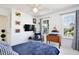 A well-lit bedroom featuring modern decor, a TV, and views of the outside through large windows at 1101 Rush Ct, Celebration, FL 34747