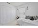 Bedroom with a white interior, featuring a large closet and window with decorations on the wall and dresser at 1101 Rush Ct, Celebration, FL 34747