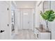 Bright entryway featuring light wood floors, white walls, and a decorative table creating an open, airy feel at 1101 Rush Ct, Celebration, FL 34747