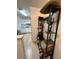 Stylish entryway with a decorative shelf, hooks, and a view into the bright kitchen with white cabinets at 1101 Rush Ct, Celebration, FL 34747