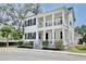 Charming two-story home boasting double porches, white siding, and black shutters, creating inviting curb appeal at 1101 Rush Ct, Celebration, FL 34747