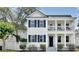 Charming two-story home with double porches and dark shutters with blue sky at 1101 Rush Ct, Celebration, FL 34747