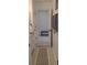 The hallway leads to the bedroom, featuring a patterned rug and access to the closet at 1101 Rush Ct, Celebration, FL 34747