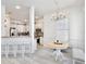 Open-concept kitchen with white cabinets, stainless steel appliances, and bar seating ideal for entertaining guests at 1101 Rush Ct, Celebration, FL 34747