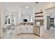 Bright and open kitchen with white cabinetry, stainless steel appliances, and a seamless transition to dining area at 1101 Rush Ct, Celebration, FL 34747