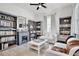 Cozy living room with bookshelves, a fireplace, natural light, and comfortable seating for relaxation at 1101 Rush Ct, Celebration, FL 34747