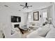 Bright living room features a decorative fireplace, ceiling fan, and stylish decor at 1101 Rush Ct, Celebration, FL 34747
