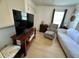 Cozy living room with a large flat screen TV, couch, and a comfortable armchair near a bright window at 1101 Rush Ct, Celebration, FL 34747