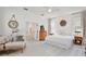 Bright main bedroom showcasing neutral tones, wood floors, and a cozy seating area at 1101 Rush Ct, Celebration, FL 34747