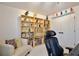 Spacious office featuring a large bookshelf filled with books and figurines, next to a white sofa at 1101 Rush Ct, Celebration, FL 34747