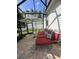 Screened patio with lounge chairs, decorative pillows, and striped umbrella for relaxing outdoors at 1101 Rush Ct, Celebration, FL 34747