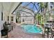 Inviting screened-in pool with a spa, complimented by outdoor seating and a brick-paved patio area at 1101 Rush Ct, Celebration, FL 34747