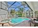Enclosed pool and spa surrounded by lush landscaping, providing a private outdoor oasis at 1101 Rush Ct, Celebration, FL 34747