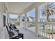 Spacious porch with chairs overlooking the neighborhood and a palm tree, perfect for relaxation at 1101 Rush Ct, Celebration, FL 34747