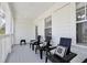 Covered front porch with three black chairs with white pillows, offering a relaxing outdoor space at 1101 Rush Ct, Celebration, FL 34747