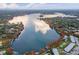 Breathtaking aerial view showcasing a serene lake surrounded by lush greenery and beautiful waterfront homes at 1140 S Orlando Ave # E11, Maitland, FL 32751