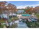 Community aerial view features a pool, boat docks, lake, and a multi-story building at 1140 S Orlando Ave # E11, Maitland, FL 32751