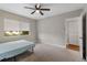 Inviting bedroom with neutral paint, carpet, and a ceiling fan at 1140 S Orlando Ave # E11, Maitland, FL 32751