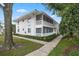 Inviting two-story condo featuring a screened-in porch and lush landscaping at 1140 S Orlando Ave # E11, Maitland, FL 32751