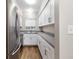 Modern kitchen with stainless steel appliances, granite countertops, and white cabinets at 1140 S Orlando Ave # E11, Maitland, FL 32751