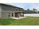 Green backyard featuring a wooden pergola on a concrete patio at 115 Bristol Forest Trl, Sanford, FL 32771