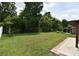 A serene backyard with a well-manicured lawn, mature trees, and privacy fence for secluded outdoor enjoyment at 115 Bristol Forest Trl, Sanford, FL 32771