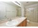 Bright bathroom with double vanity sinks, large mirror, and glass-enclosed shower, providing a luxurious feel at 115 Bristol Forest Trl, Sanford, FL 32771