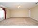 A large bedroom with neutral carpet, ceiling fan, and natural light at 115 Bristol Forest Trl, Sanford, FL 32771
