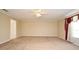 A large bedroom with neutral carpet, ceiling fan, and natural light at 115 Bristol Forest Trl, Sanford, FL 32771