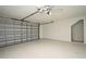Spacious two-car garage featuring an updated epoxy floor and ceiling fan at 115 Bristol Forest Trl, Sanford, FL 32771