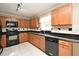 Kitchen features wooden cabinets, black appliances, granite countertops and tile backsplash at 115 Bristol Forest Trl, Sanford, FL 32771