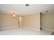 Open living room features tile flooring, neutral walls, chandelier and staircase to the second floor at 115 Bristol Forest Trl, Sanford, FL 32771