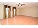 Living room with wood floors, a ceiling fan, large window, and neutral color scheme at 115 Bristol Forest Trl, Sanford, FL 32771
